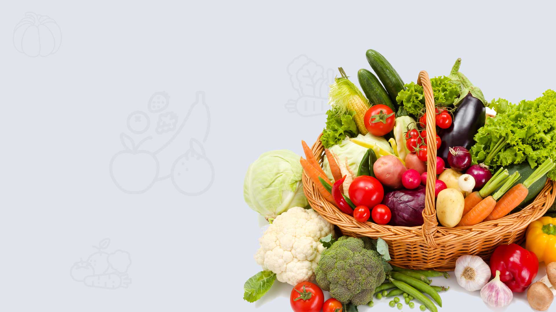 Wicker basket overflowing with fresh vegetables and fruit